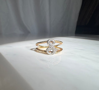 Diamond initial S ring showing the letter and braided gold shoulders.