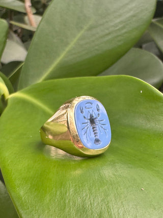 Angled view of a blue chalcedony intaglio ring showing the band.